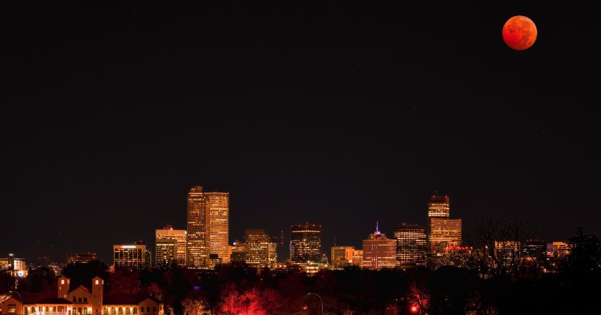 A landscape scene of a Beaver Blood Moon over Denver, Colorado at night. (Cover Image Source: Getty | Wirestock)