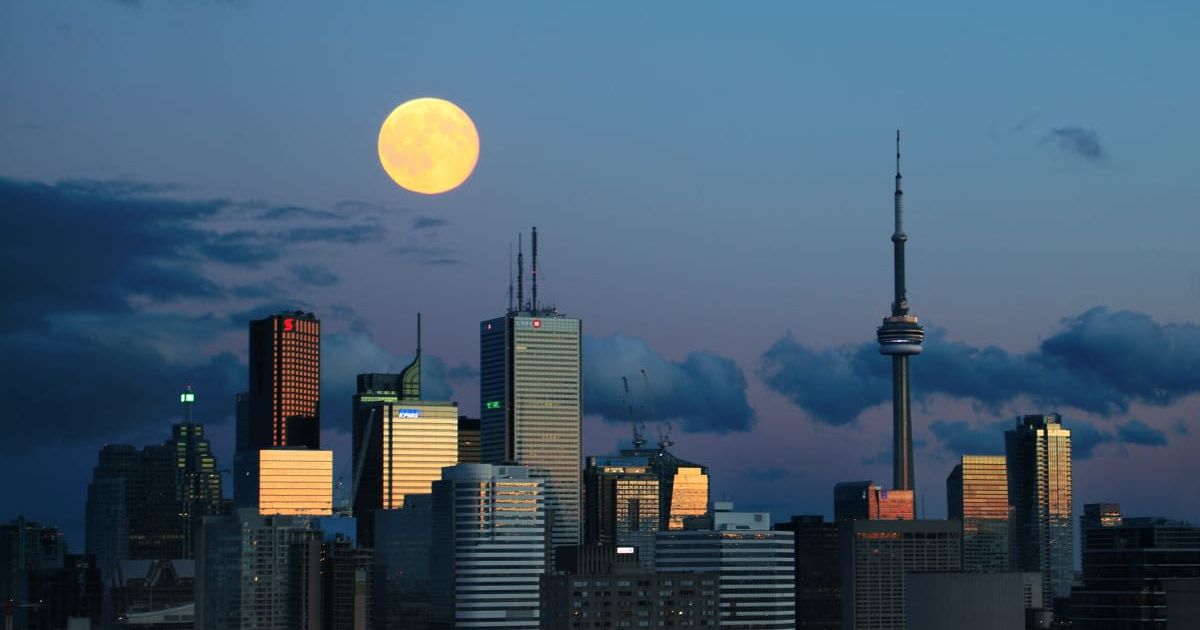 The second full moon of July rising above Toronto downtown right after sunset. (Cover Image Source: Getty Images| Steve Burns)