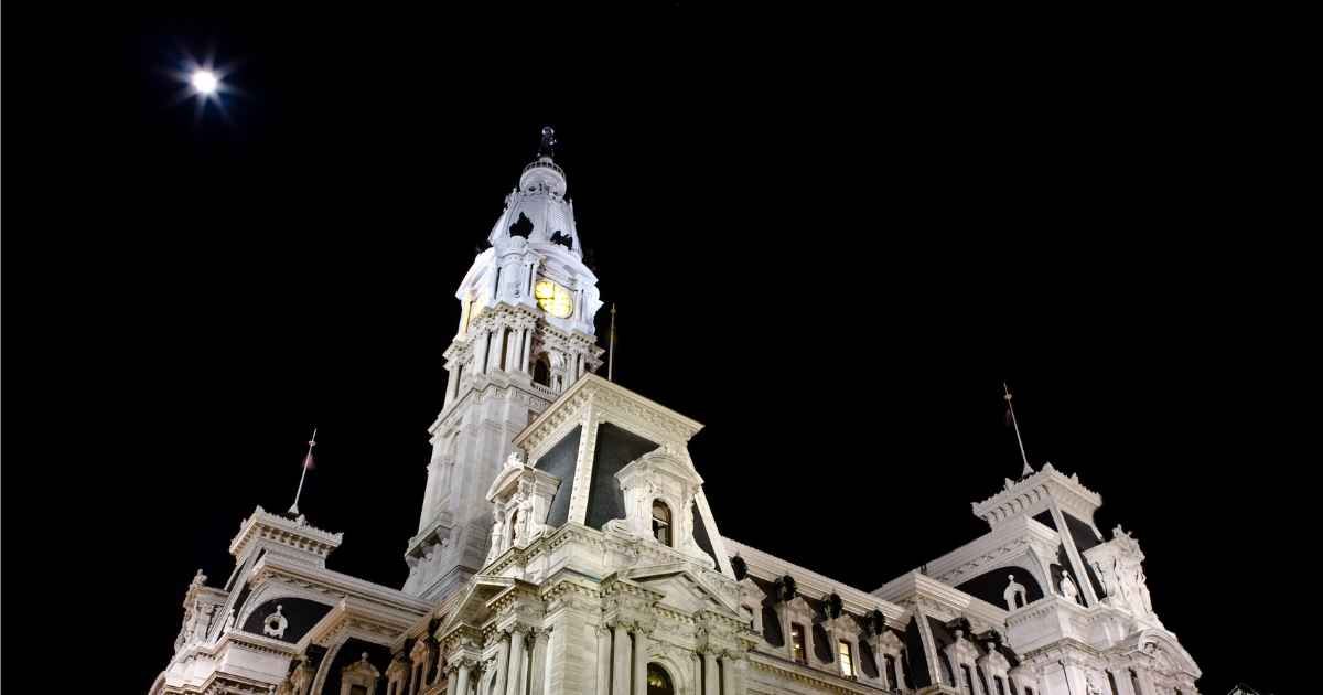 A nighttime shot of Philadelphia's City Hall isolated with the moon. (Cover Image Source: Getty Images| dovate)