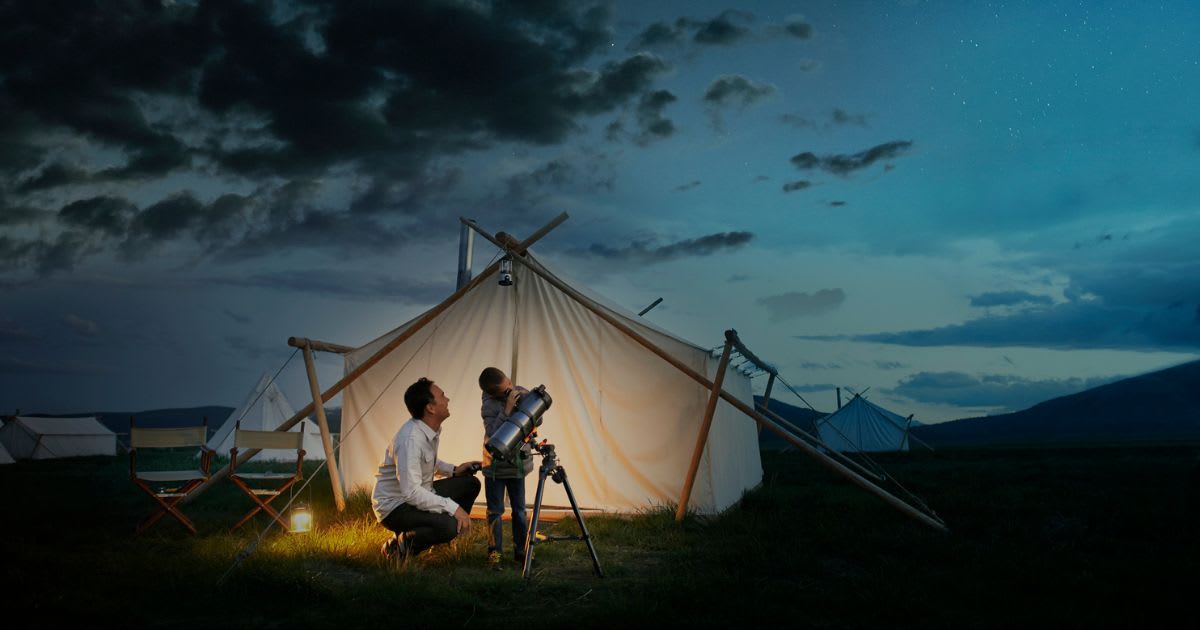 Father and son are looking up at the night sky through a telescope (Representative Cover Image Source: Getty | Dana Neibert)