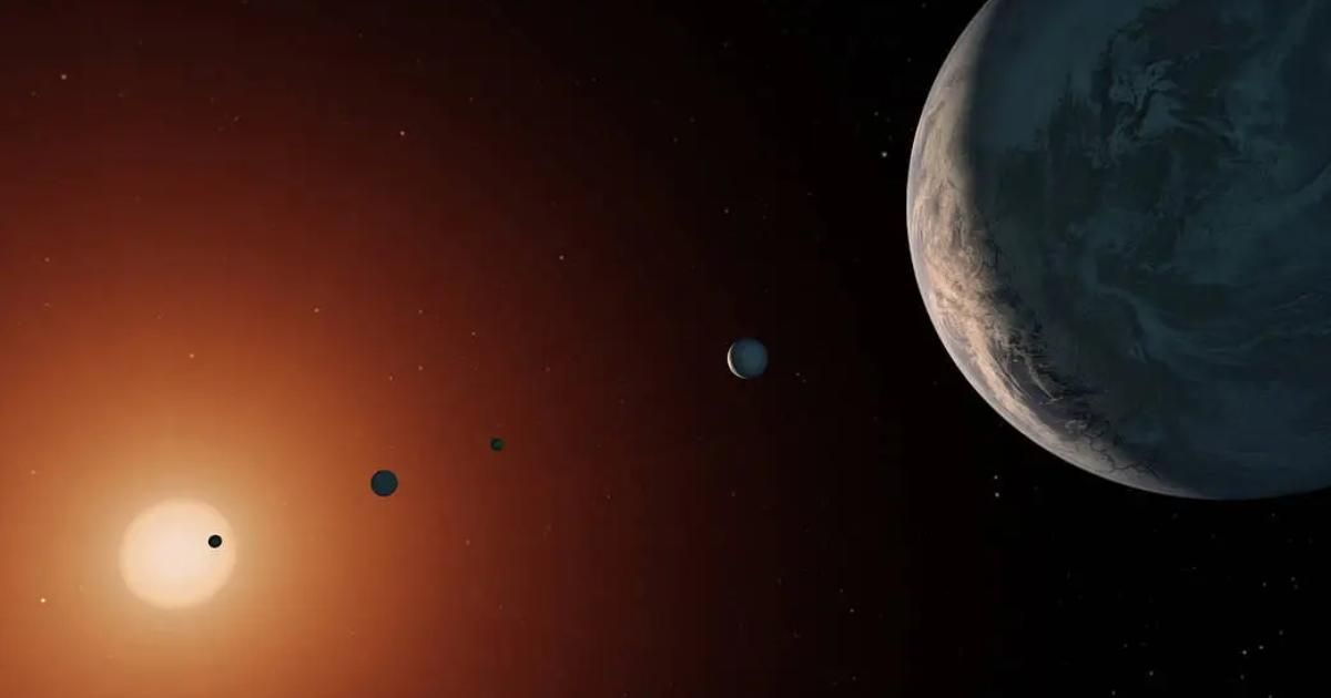 This illustration shows what the TRAPPIST-1 system might look like from a vantage point near planet TRAPPIST-1f (at right) (Cover Image Source: NASA/JPL-Caltech)
