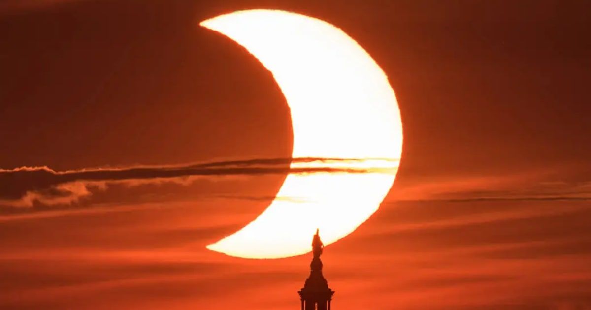 A partial solar eclipse is seen as the Sun rises behind the United States Capitol Building (Cover Image Source: NASA | Bill Ingalls)