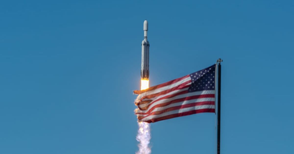  A SpaceX Falcon Heavy passes the American Flag located at NASA's Launch Complex 39 Press Site as it launches the NOAA GOES-U weather satellite at 5:26 P.M. (Cover Image Source: Getty | Brandon Moser)