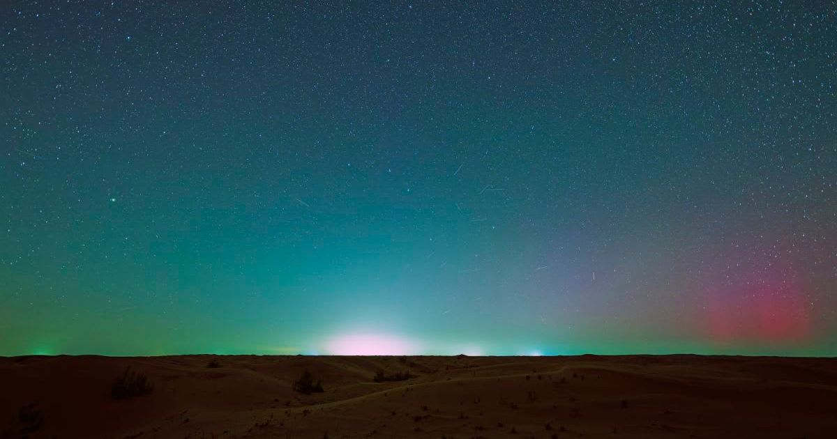 Auroras and airglow over the desert (Representative Cover Image Source: Getty | 	zhengshun tang)