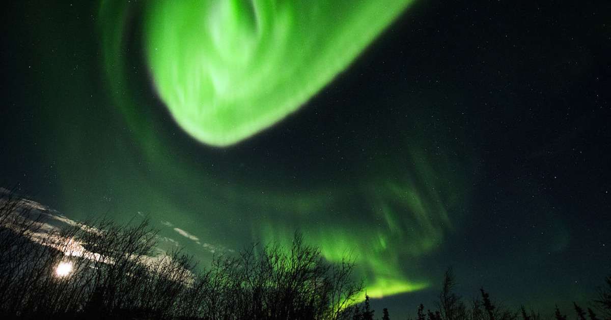 The Aurora Borealis appears in the sky on January 8, 2017 near Ester Dome mountain about 10 miles west of Fairbanks, Alaska (Image Source: Getty | Lance King)