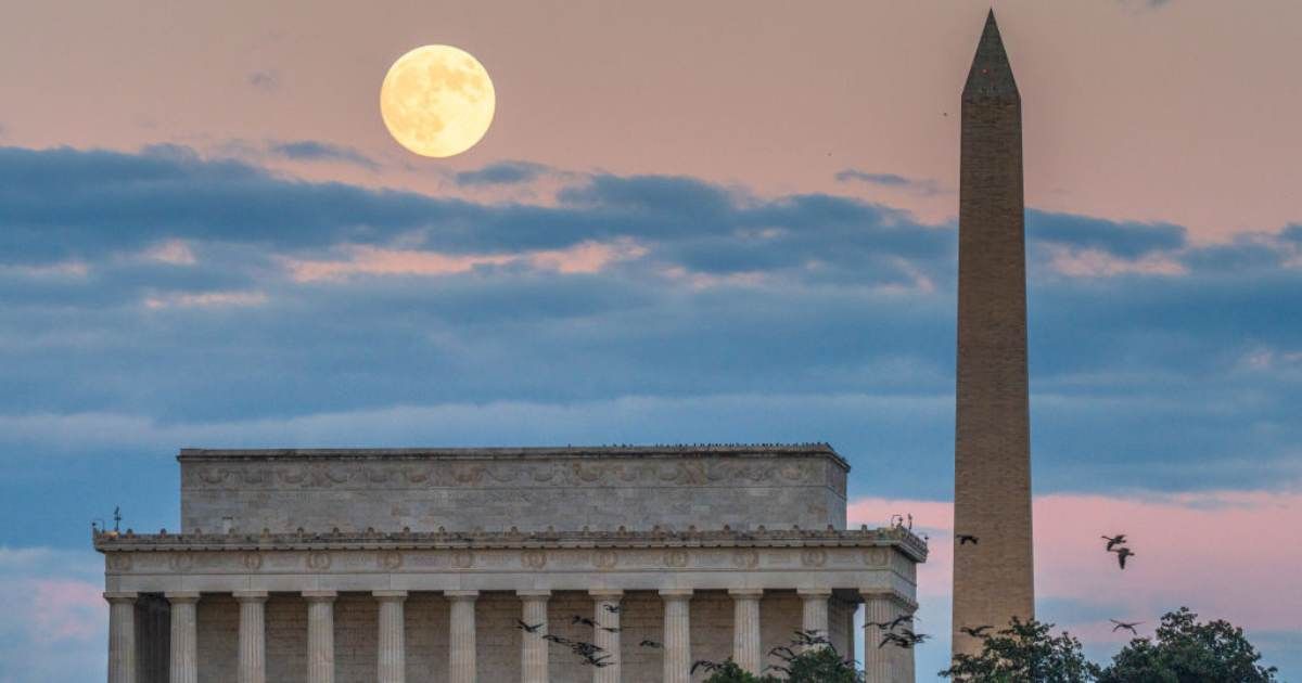 The 99.5 percent waxing Hunters Supermoon rises behind the Lincoln Memorial and the Washington Monument as a flock of geese passes by on October 16, 2024 (Cover Image Source: Getty | J. David Ake)