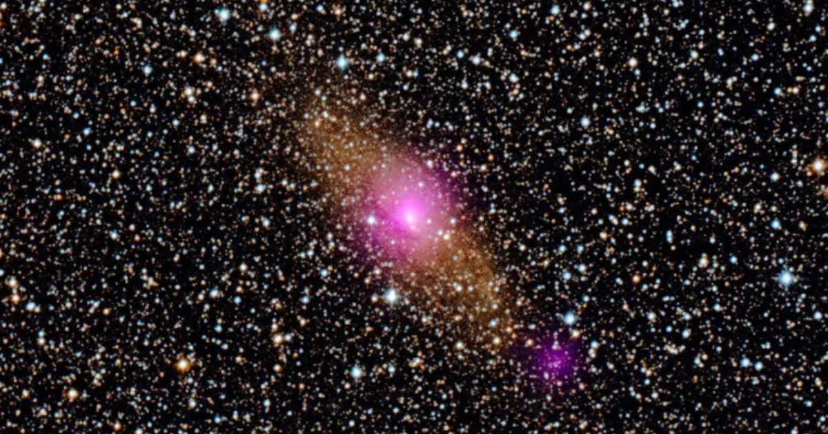 The magenta spots in this image show two black holes in the Circinus galaxy: the supermassive black hole at its heart, and a smaller one closer to the edge (Cover Image Source: NASA/JPL)