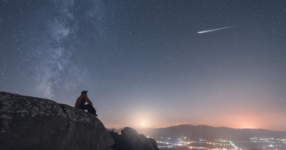 A man watching a shooting star, and the Milky Way. (Representative Cover Image Source: Getty | Carlos Fernandez)