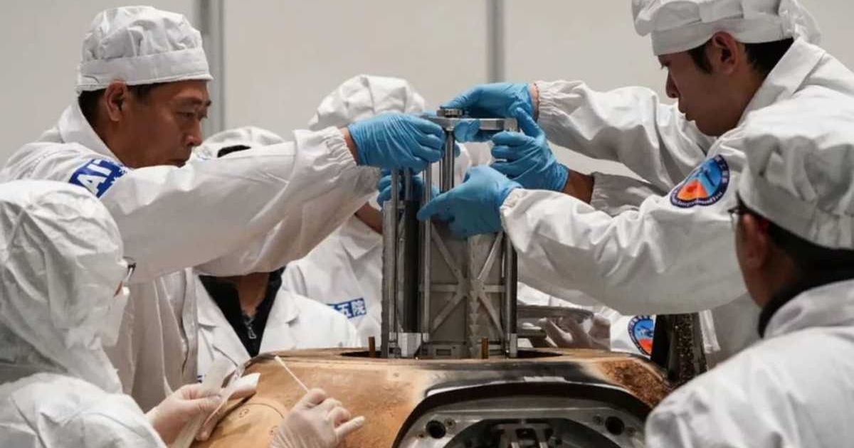 Technicians remove the sample canister from China's Chang'e 5 spacecraft, which returned moon dirt and rock to Earth in December 2020. (Representative Cover Image Source: National Astronomical Observatories | CAS)