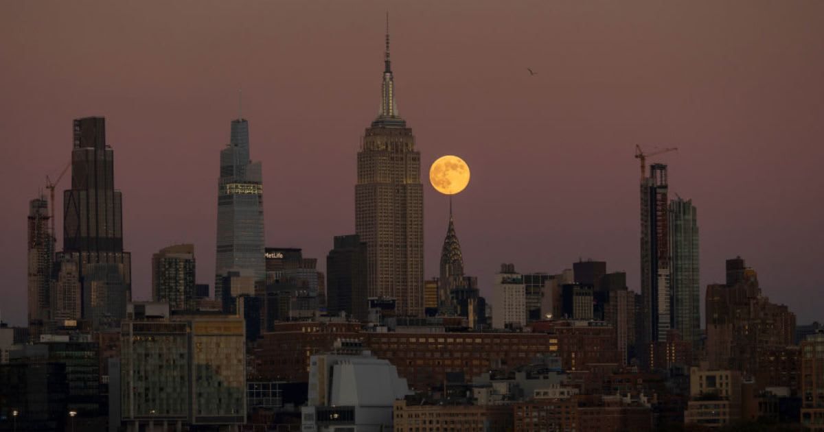 The full Beaver Supermoon rises behind the Chrysler Building and the Empire State Building in New York City as the sun sets on November 15, 2024 (Cover Image Source: Getty | Gary Hershorn)