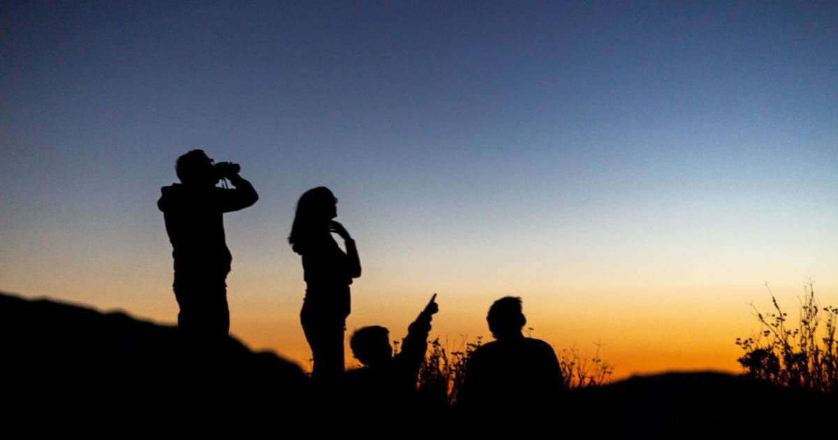 People watch for the appearance of Comet NEOWISE over the San Gabriel Mountains National Monument as the sky darkens on July 19, 2020 (Representative Cover Image Source: Getty | David McNew)