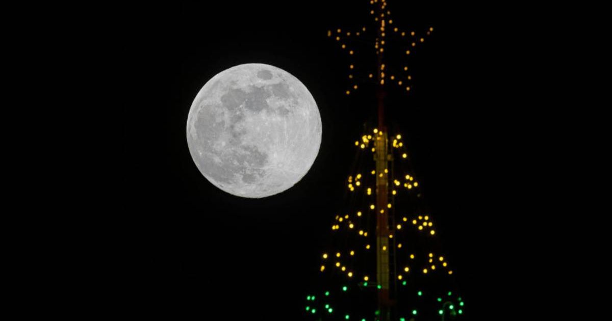 The Cold Moon rises behind the SkyTower at SeaWorld San Diego which was decorated in holiday lights on December 14, 2024 in San Diego, California (Cover Image Source: Getty | Kevin Carter)