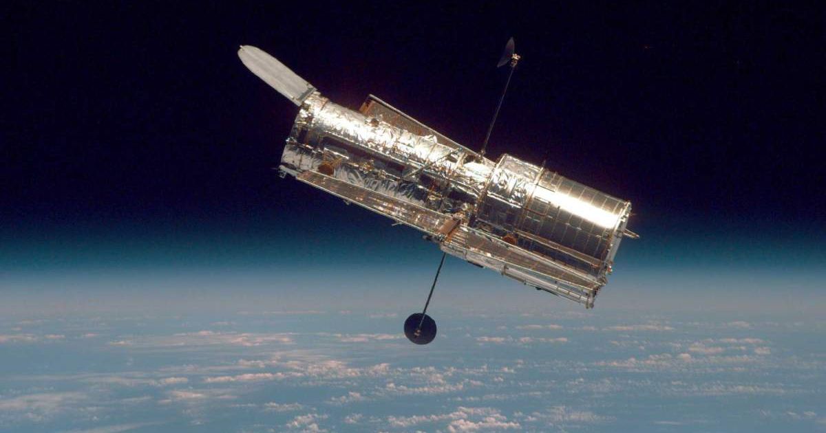 The Hubble Space Telescope drifts through space in a picture taken from the Space Shuttle Discovery during Hubble's second servicing mission in 1997. (Representative Cover Image Source: Getty Images | Photo by NASA)