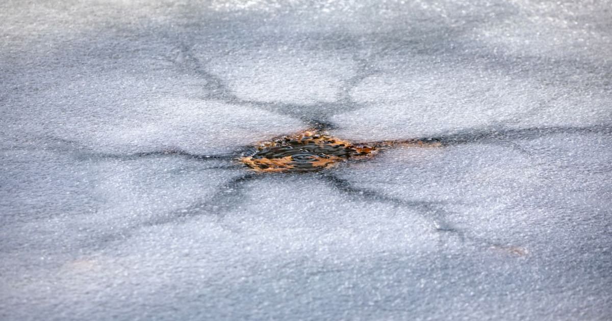 Crack in ice of a frozen lake forming a lake star (Representative Cover Image Source: Getty Images | Photo by Ali Majdfar)