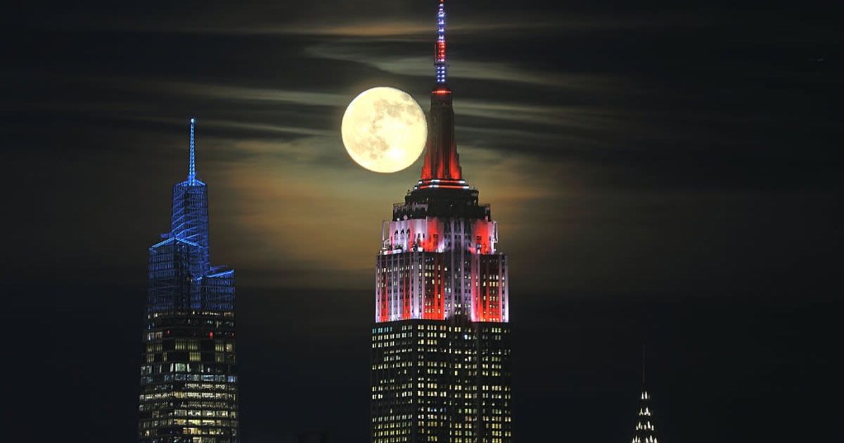 A 97 percent illuminated waning gibbous Beaver Moon rises behind One Vanderbilt, the Chrysler Building, and the Empire State Building (Representative Cover Image Source: Getty | Gary Hershorn)