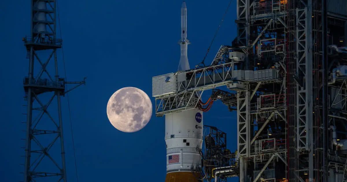 A gibbous, almost-Full Moon in the backdrop of the Artemis I SLS rocket at Launch Complex 39B at NASA's Kennedy Space Center in Florida on June 14, 2022. (Representative Cover Image Source: NASA | Ben Smegelsky)