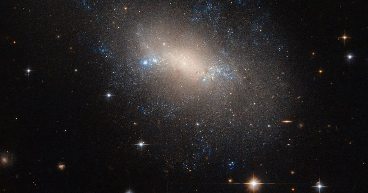 The irregular galaxy NGC 2337 appears slightly lopsided in this Hubble view within the constellation Lynx. (Cover Image Source: ESA/Hubble & NASA)