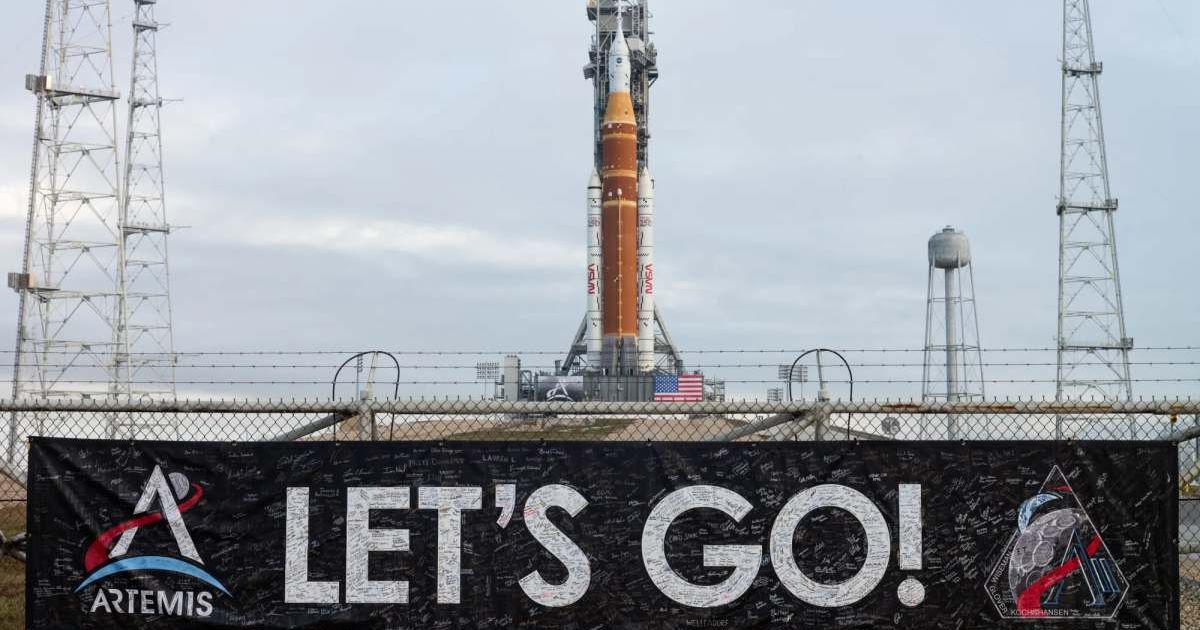 A banner covered with the signatures of NASA employees and contractors is seen on the perimeter fence of Launch Complex 39B with NASA’s Artemis II SLS rocket and Orion spacecraft in the background. (Cover Image Source: NASA | Joel Kowsky)