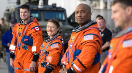What sets the Artemis II crew's bright orange spacesuit apart from past missions' gear