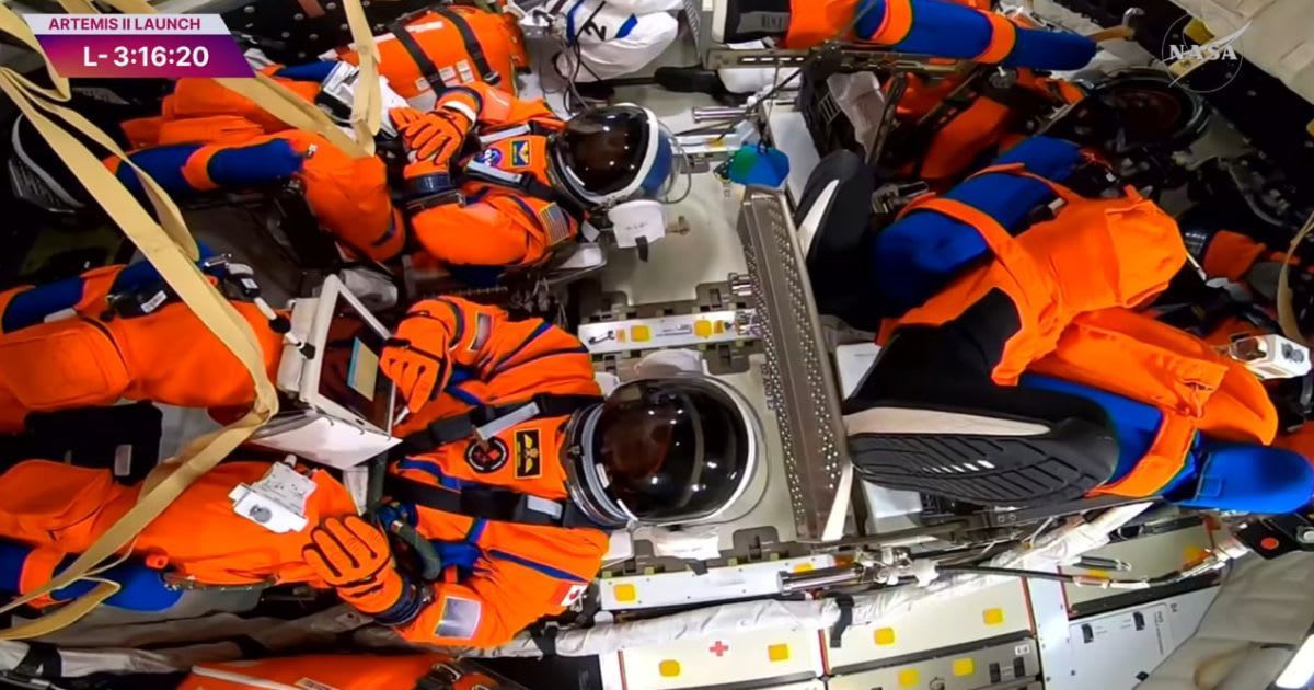 Artemis II crew members strapped in inside the Orion spacecraft atop NASA’s SLS ahead of launch. (Cover Image Source: Screengrab from NASA's YouTube livestream)