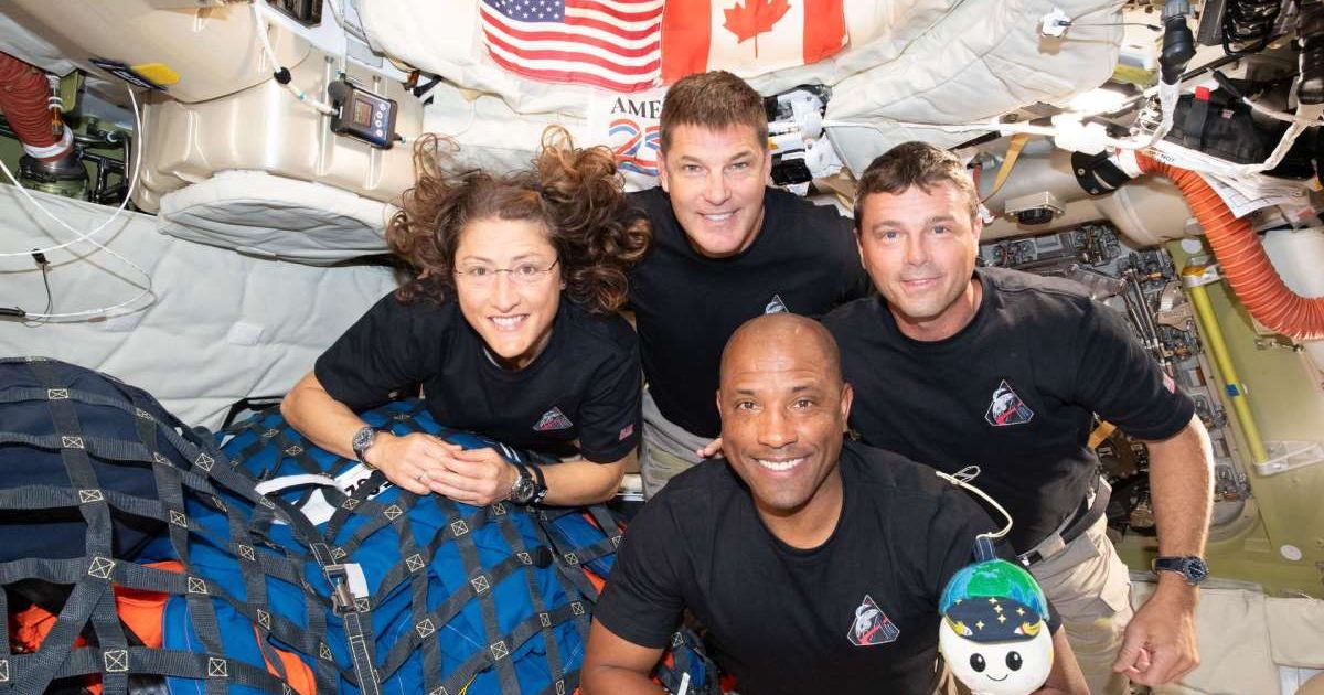 The Artemis II crew pause for a group photo with their zero gravity indicator “Rise,” inside the Orion spacecraft. (Cover Image Source: NASA)