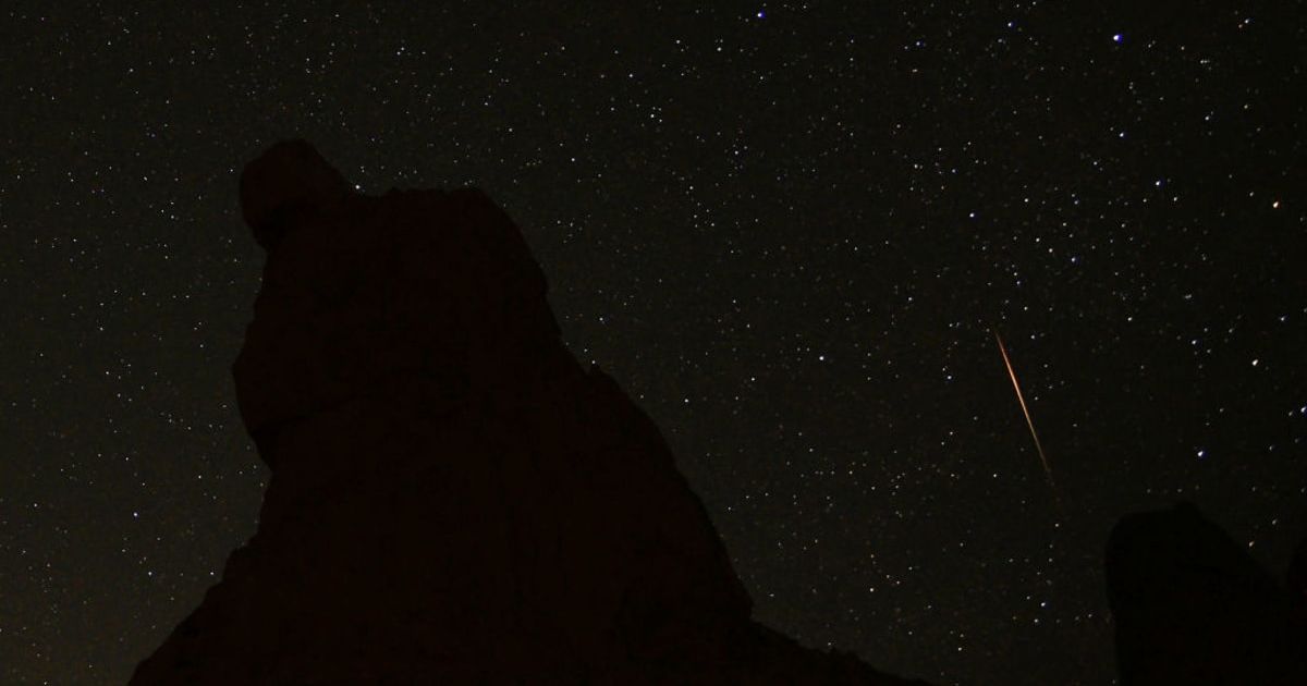 A meteorite streaks across the night sky above a large tufa spire at Trona Pinnacles in the Mojave Desert near Death Valley, June 15, 2012 in Trona, California. (Representative Cover Image Source: Bob Riha, Jr./Getty Images)