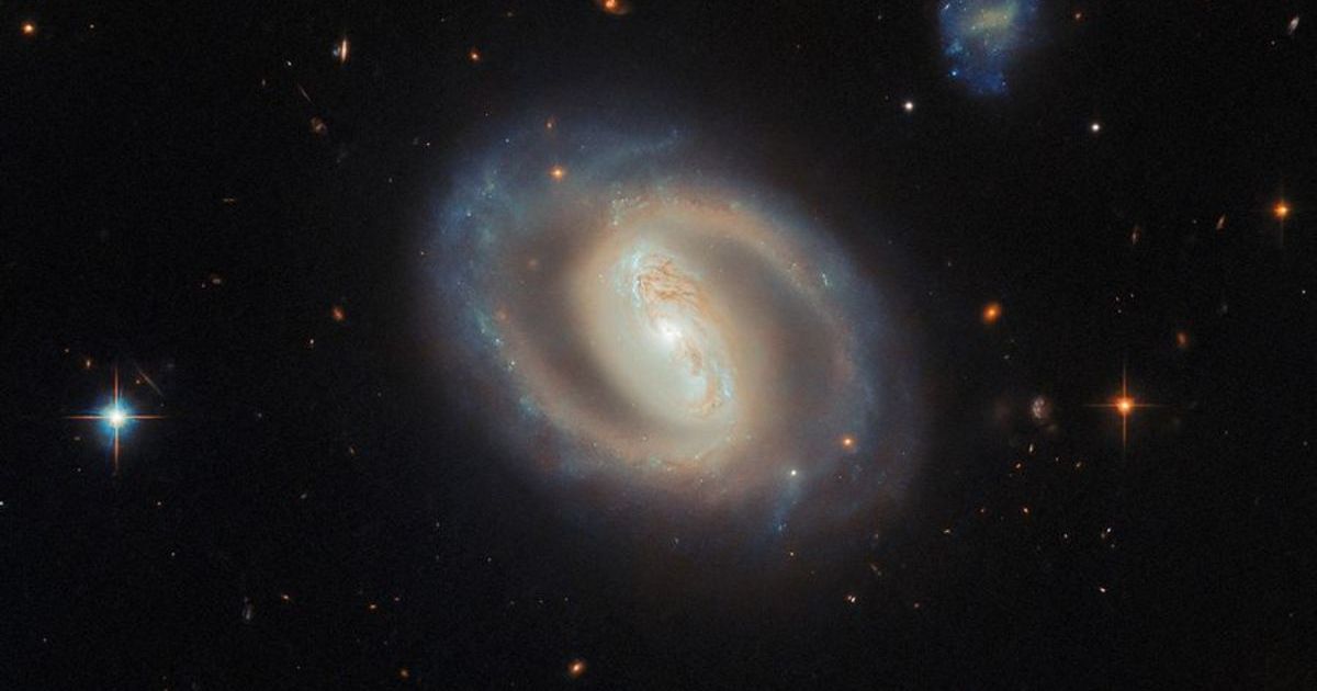 The barred spiral galaxy IC 486 glows with a soft, ethereal light in this new NASA Hubble Space Telescope image. (Cover Image Source: ESA/Hubble & NASA, M. J. Koss, A. J. Barth)