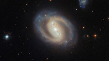NASA's Hubble provides spectacular views of a barred spiral galaxy 380 million light-years away