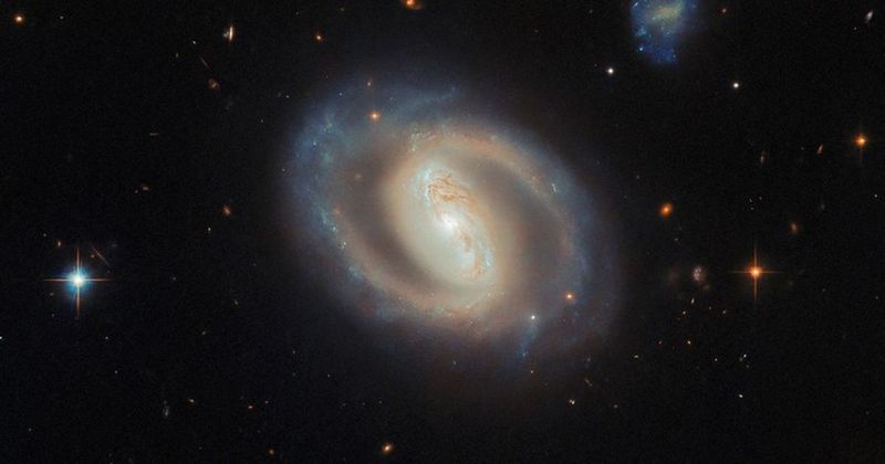 NASA's Hubble provides spectacular views of a barred spiral galaxy 380 million light-years away
