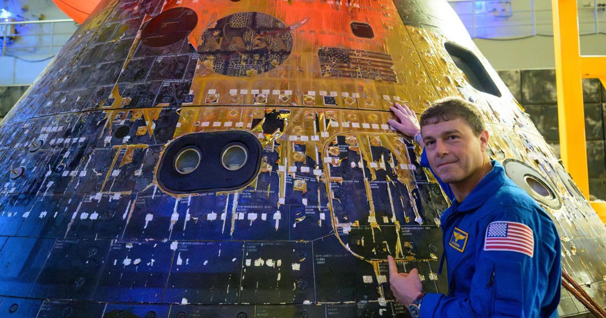 Artemis II commander Reid Wiseman points at the recovered Orion spacecraft in the well deck of USS John P. Murtha, in a picture taken on April 11, 2026. (Cover Image Source: NASA/Bill Ingalls)