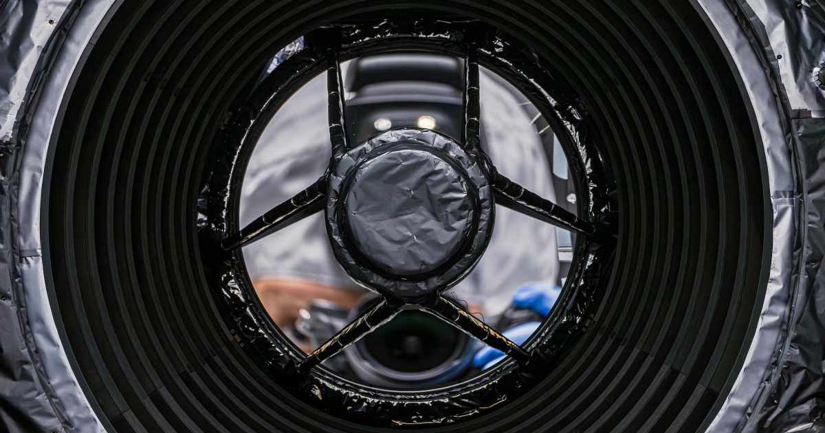 In this photo, which peers directly down the barrel of Roman’s telescope, the photographer’s camera is reflected in the primary mirror. (Cover Image Source: NASA | Sydney Rohde)