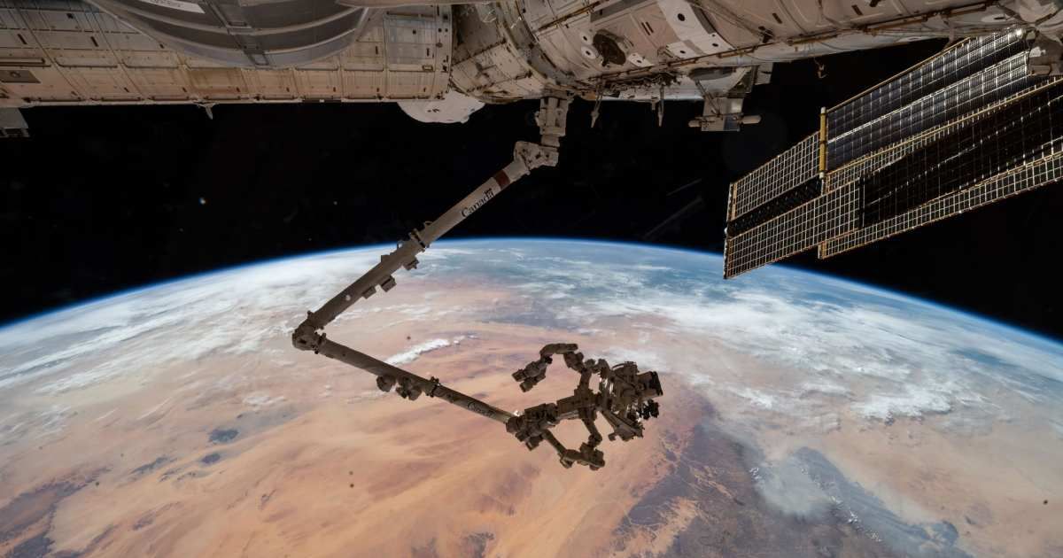 The International Space Station’s 57.7-foot-long robotic arm, Canadarm2, with its fine-tuned robotic hand, Dextre, attached, is pictured extending from the Harmony module. (Cover Image Source: NASA | JPL-Caltech)