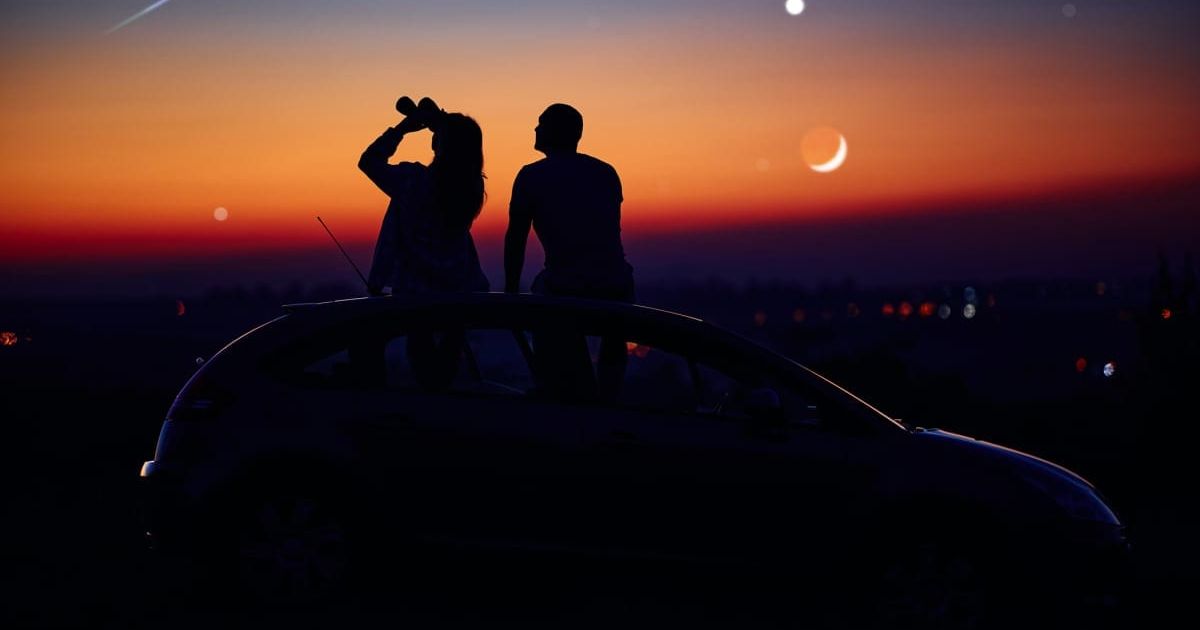A couple stargazing together with a pair of binoculars. (Representative Image Source: Getty | m-gucci)