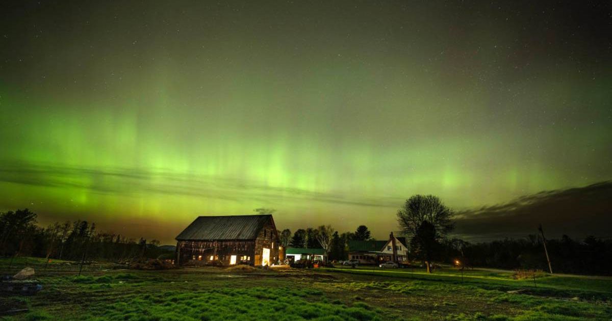  The northern lights, or aurora borealis, fill the sky with green ribbons of electrically charged particles over the barn and pastures at Greaney's Turkey Farm in Mercer, Maine. (Representative Image Source: Getty | Michael Seamans)