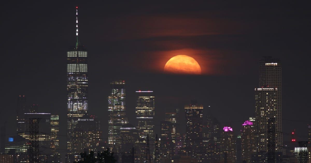 The Buck Moon rises behind Lower Manhattan and One World Trade Center in New York City on July 5, 2020. (Cover Image Source: Gary Hershorn/Getty Images)
