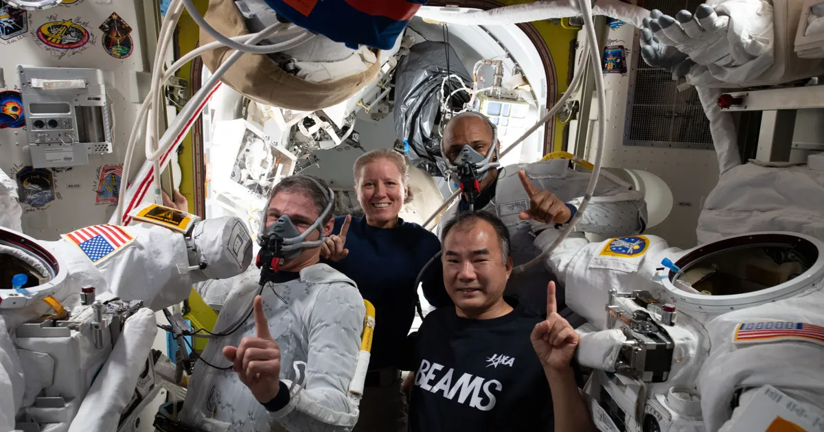 Clockwise from bottom right: JAXA astronaut Soichi Noguchi and NASA astronauts Michael Hopkins, Shannon Walker, and Victor Glover prepare for a spacewalk inside an airlock aboard the International Space Station. (Cover Image Source: NASA/Kate Rubins)