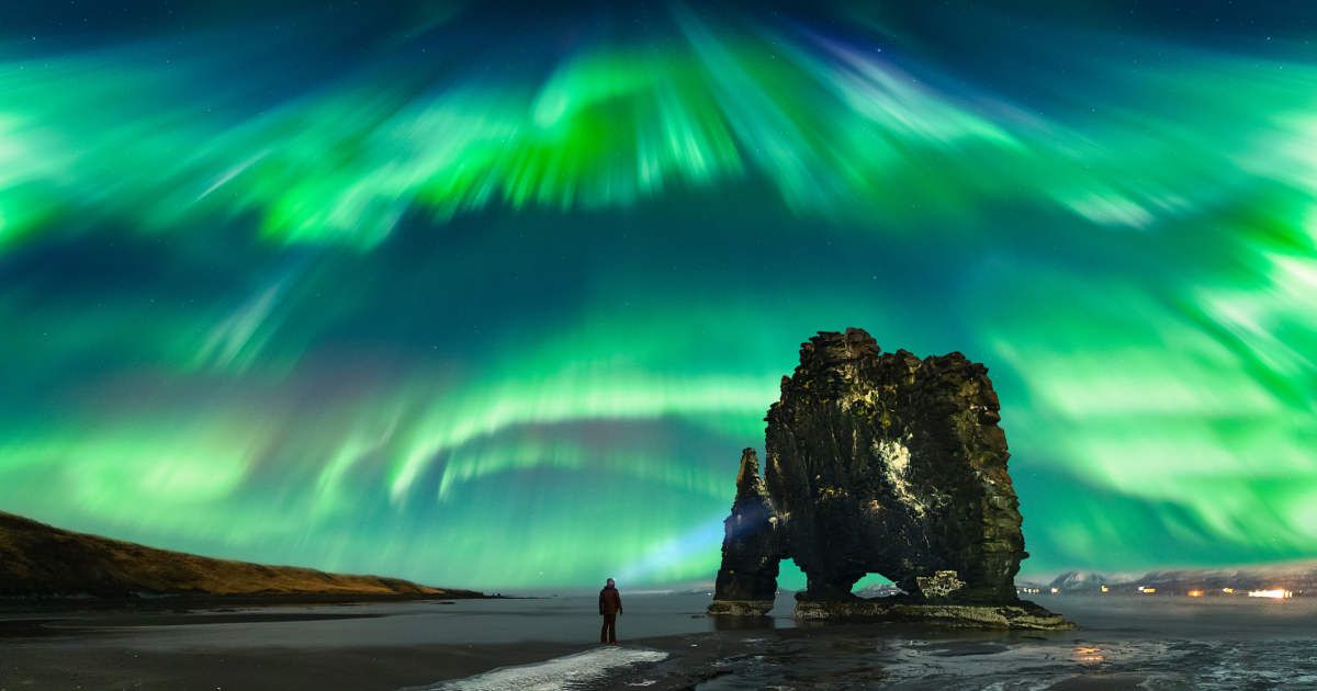 Man watching the Aurora Borealis above the Hvítserkur rock formation, Northwest Iceland, Golden Circle Route, Vatnsnesvegur, Iceland (Representative Cover Image Source: Getty | Juan Maria Coy Vergara)