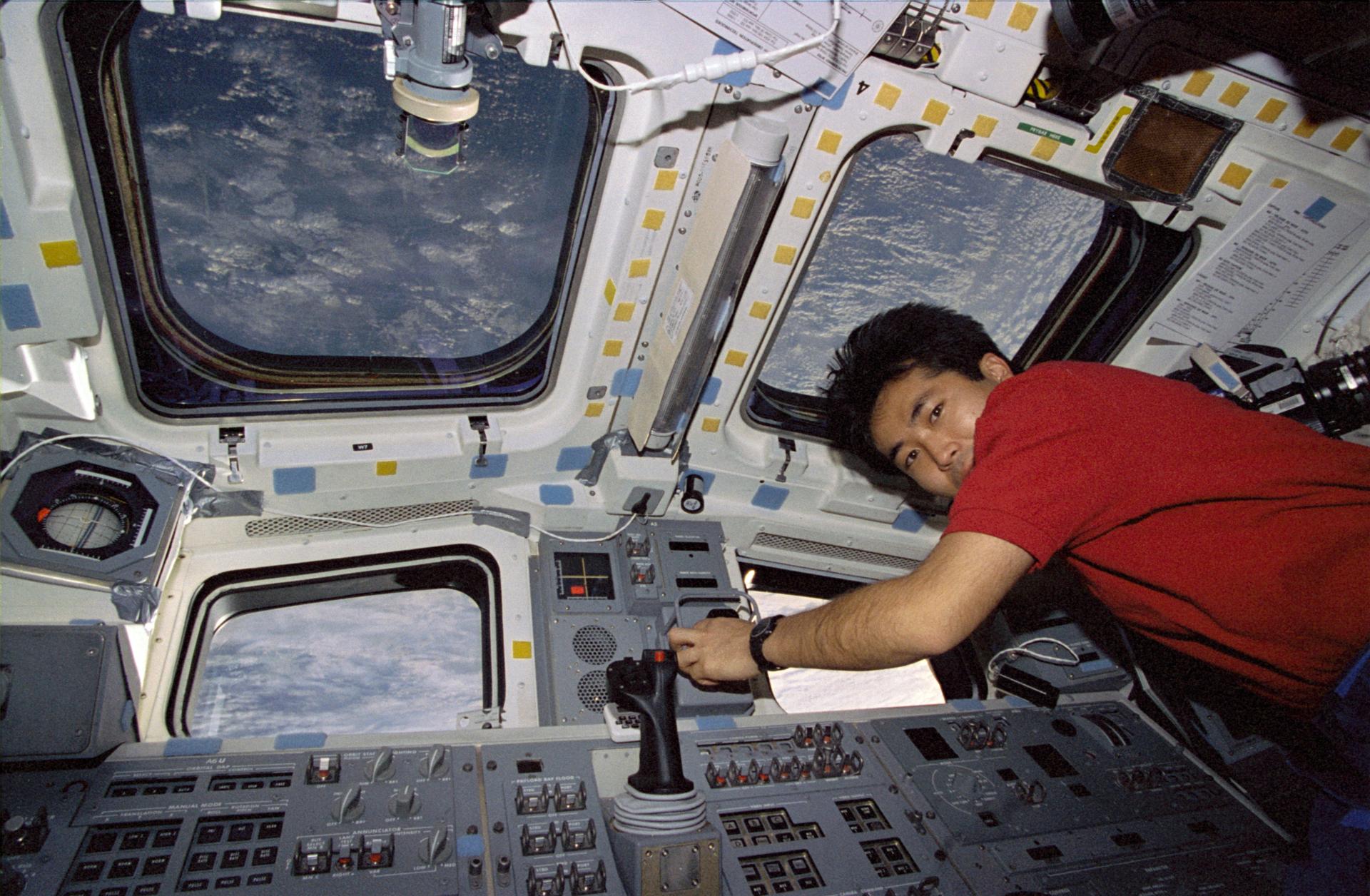 Astronaut Koichi Wakata operates the Remote Manipulator System (RMS) on the aft flight deck of the Earth-orbiting Space Shuttle Endeavour. (Image Source: NASA)