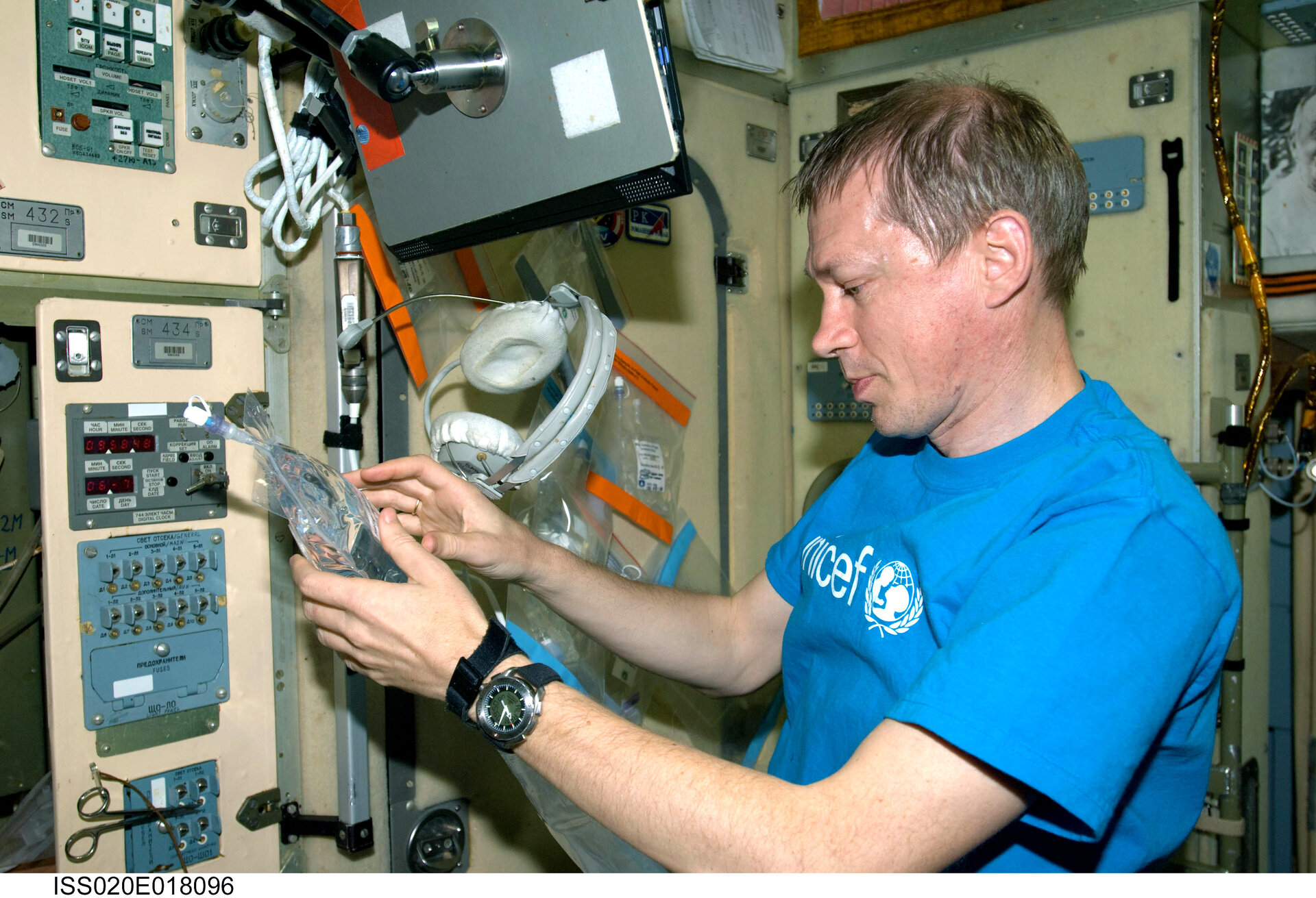 ESA astronaut Frank De Winne collects water samples at the galley in the Zvezda Service Module of the International Space Station for inflight analysis