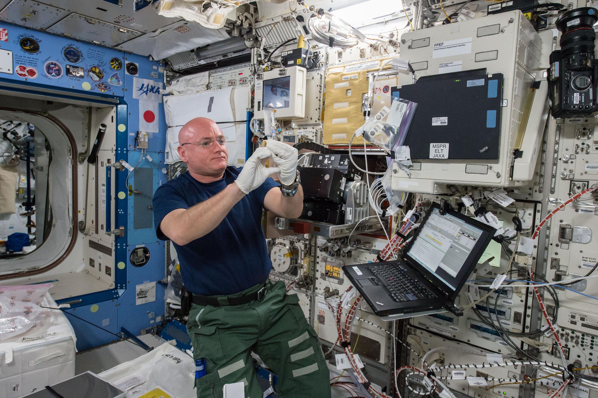 NASA astronaut Scott Kelly is seen performing the Space Aging experiment. (Image Source: NASA)