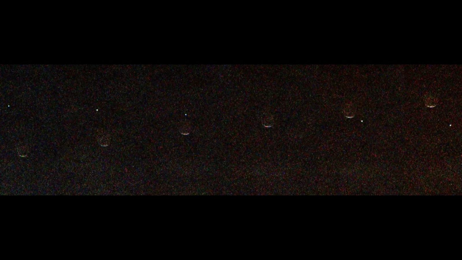 This composite of seven images show Earth (visible as a dot) passing behind the Martian moon Phobos during the occultation on July 2, 2026.
