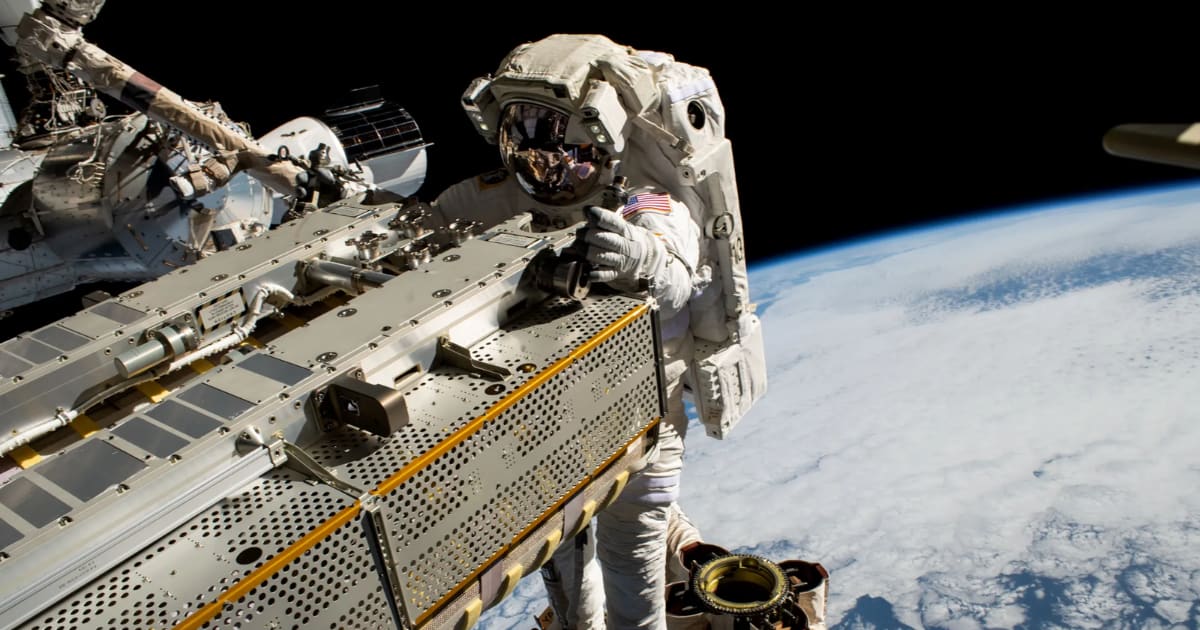 A NASA astronaut maneuvering a roll-out solar array toward the International Space Station’s truss structure 257 miles above the Pacific Ocean. (Cover Image Source: NASA)