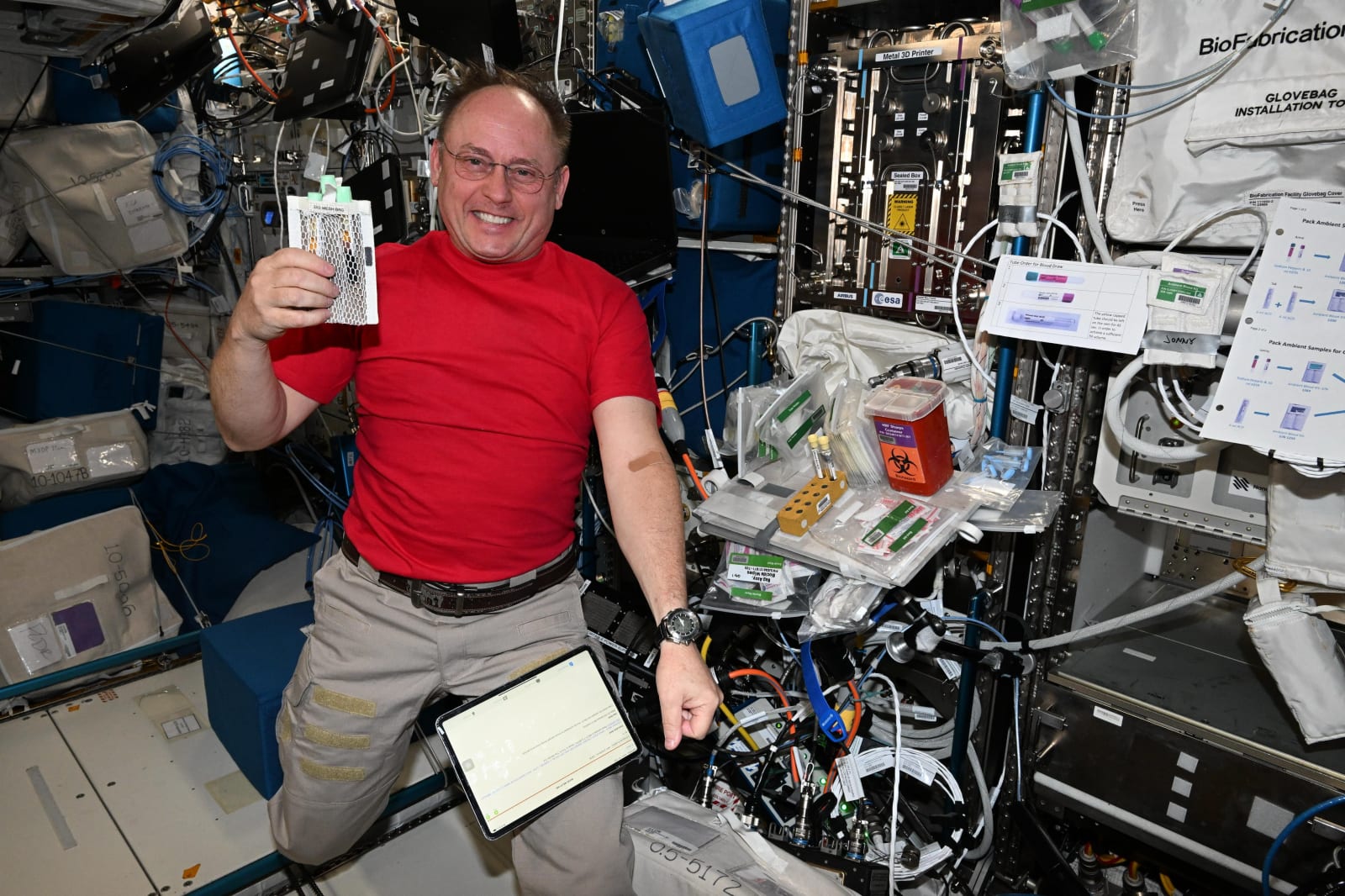 NASA astronaut Mike Fincke shows off blood samples collected inside the International Space Station.