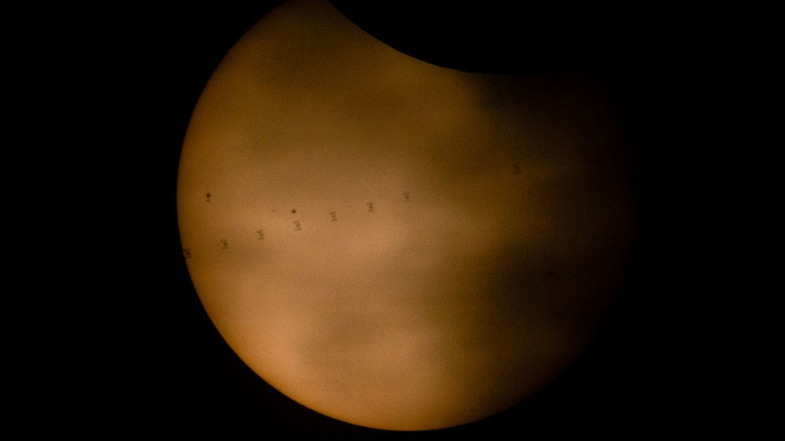 Composite image of the International Space Station transiting the Sun during the solar eclipse, August 12, 2026.