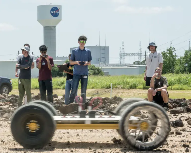 NASA Robotics Academy students navigate the lunar wheel prototype Scotch Pad Tyres fitted on the MicroChariot rover at Johnson’s Rock Yard.