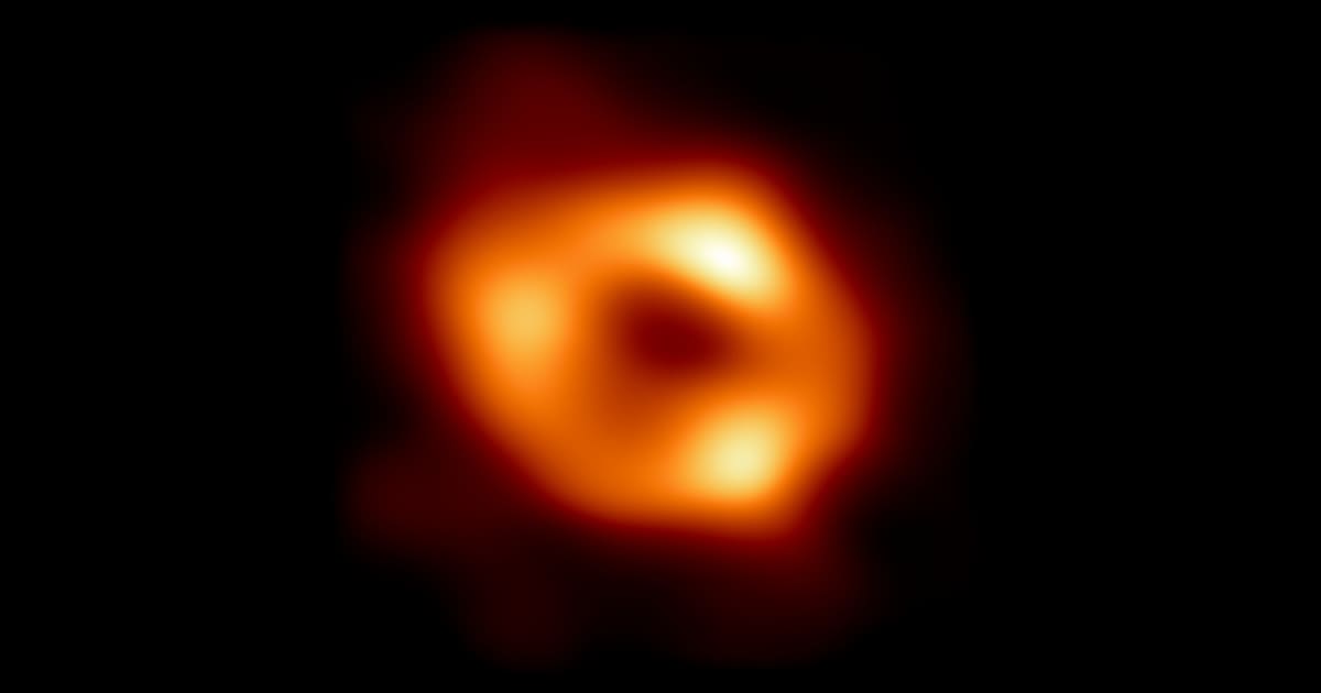 In this handout photo provided by NASA, this is the first image of the supermassive black hole at the centre of our galaxy, with an added black background to fit wider screens (Image Source: Getty | Photo Credit: NASA)