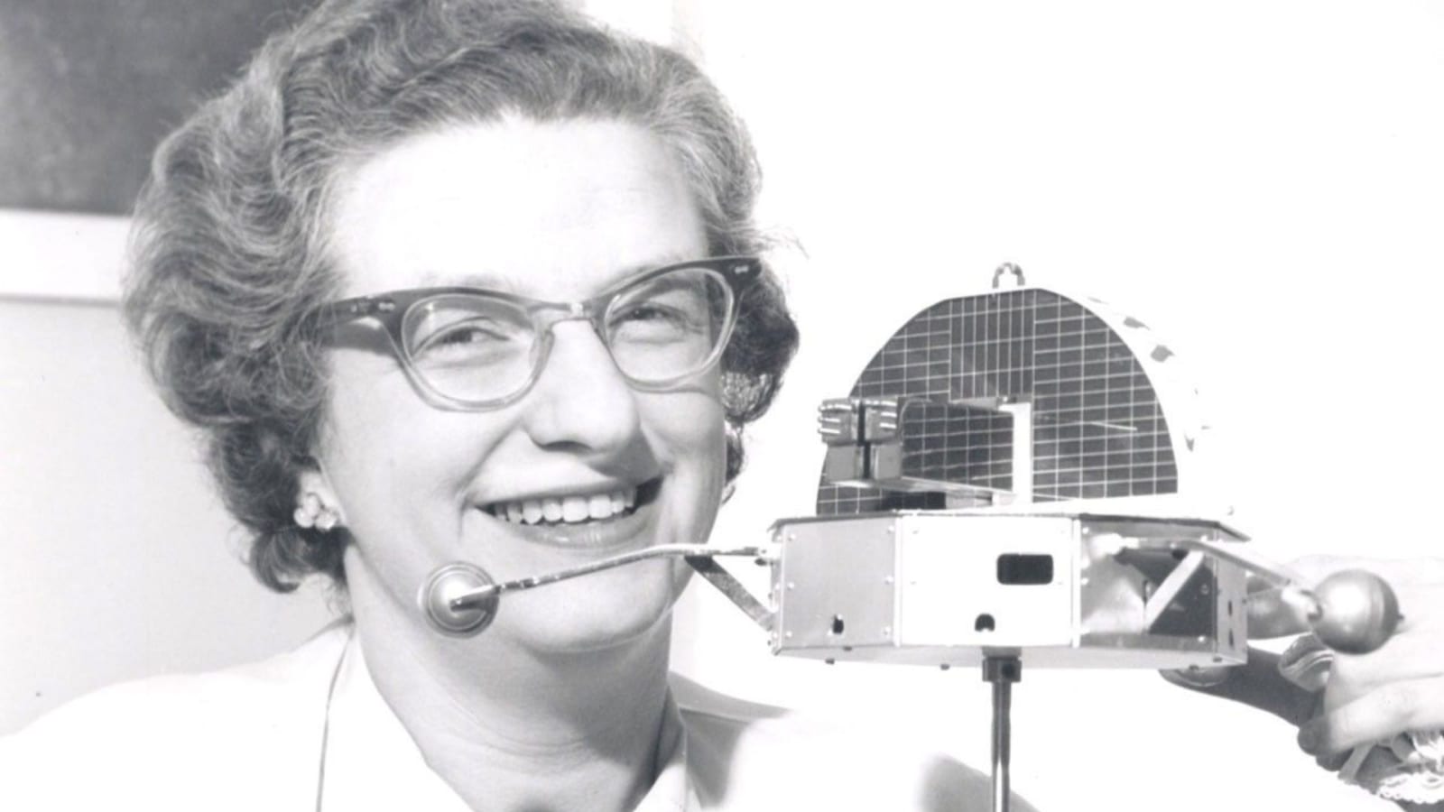 Dr. Nancy Grace Roman is shown with a model of the Orbiting Solar Observatory (OSO) in 1962.