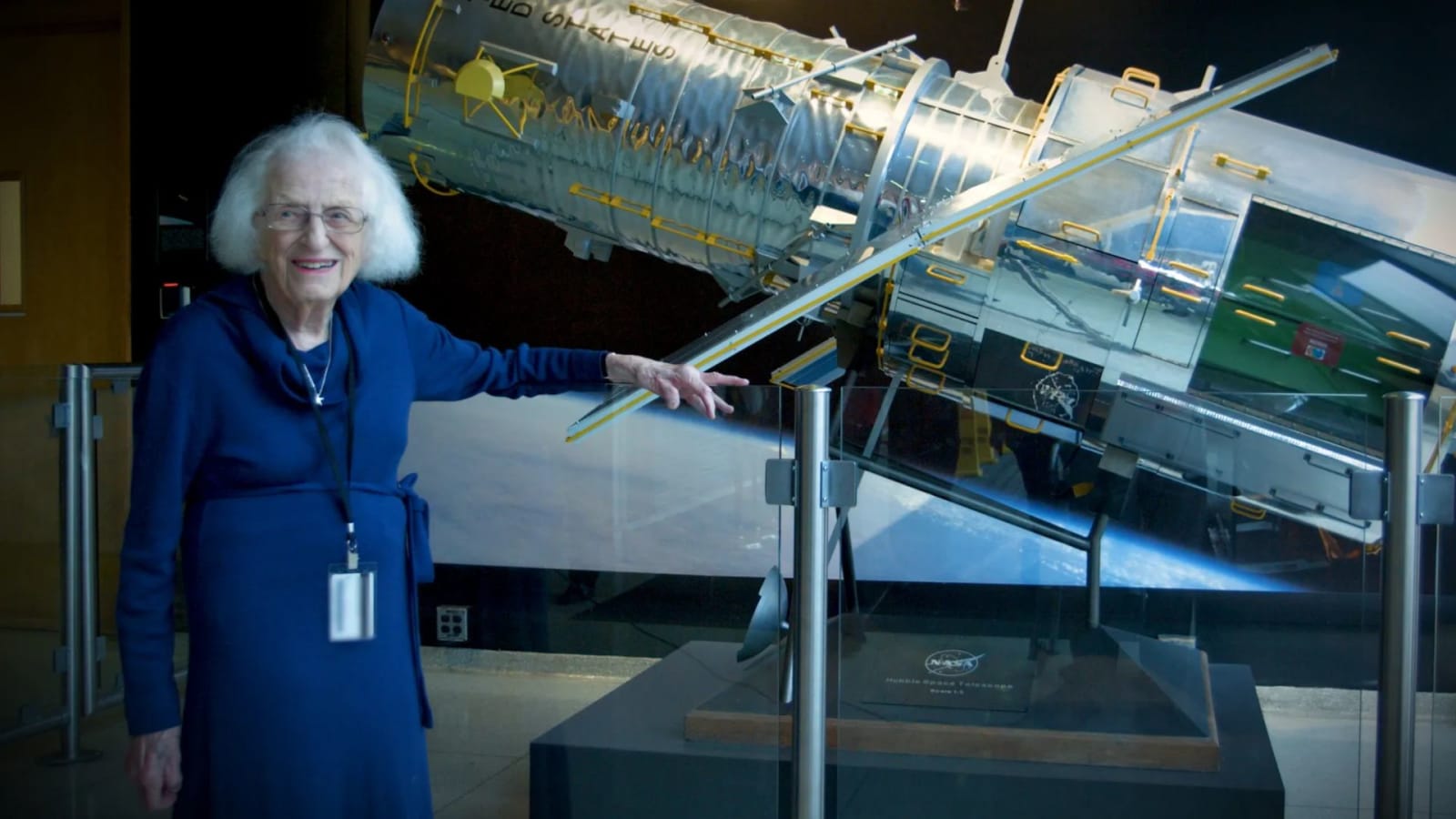 Nancy Grace Roman stands next to a scale model of the Hubble Space Telescope outside the Hubble control center at Goddard Space Flight Center in Greenbelt, MD.