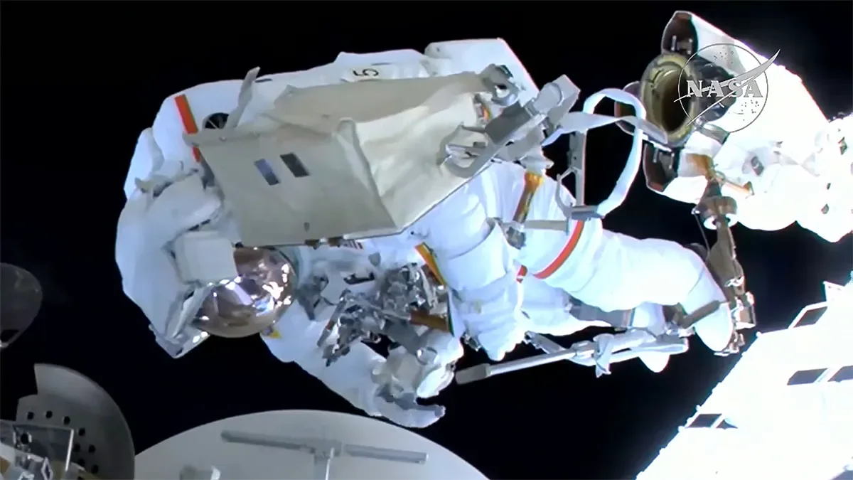 NASA astronaut Anil Menon is attached to the Canadarm2 robotic arm as it guides him toward the worksite where he and ESA astronaut Sophie Adenot (out of frame) installed a space-to-ground antenna on the International Space Station. NASA