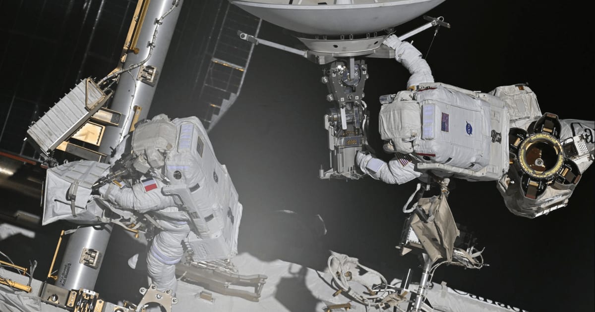 From left, Sophie Adenot of ESA and Anil Menon of NASA working together outside the International Space Station on Aug. 18, 2026. (Cover Image Source: Roscosmos/Anna Kikina)